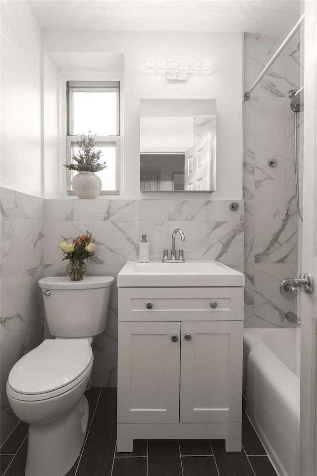 full bathroom with tile walls, tile patterned flooring, vanity, toilet, and tub / shower combination