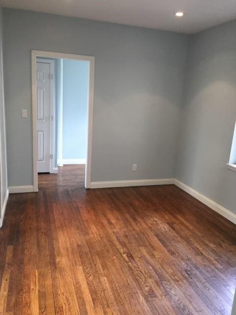 spare room with dark wood-type flooring