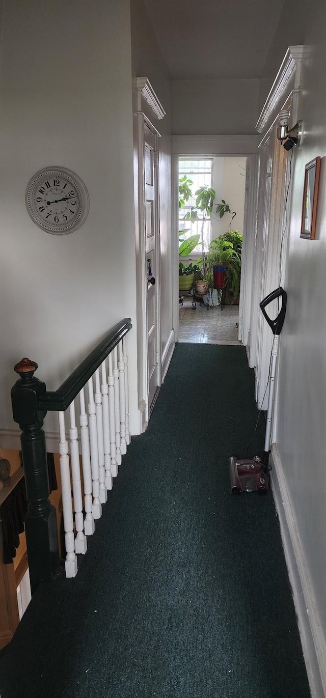 hallway featuring dark carpet