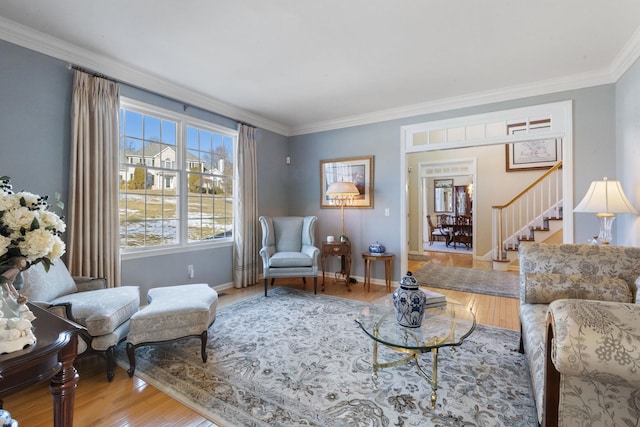 living room with hardwood / wood-style flooring and ornamental molding