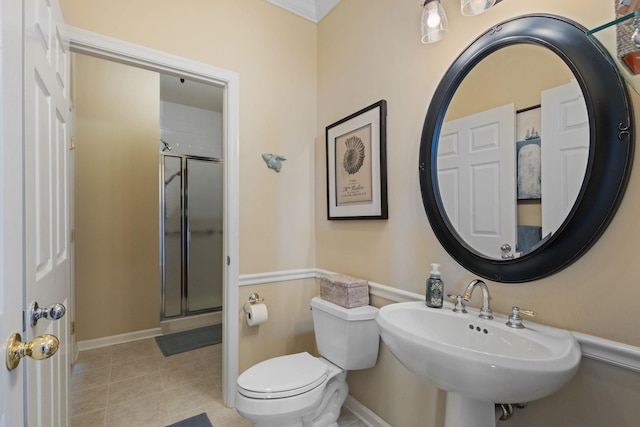 bathroom with sink, tile patterned floors, a shower with door, and toilet