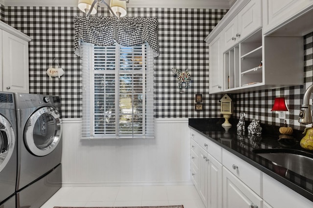 laundry room with cabinets, washing machine and dryer, sink, and light tile patterned floors