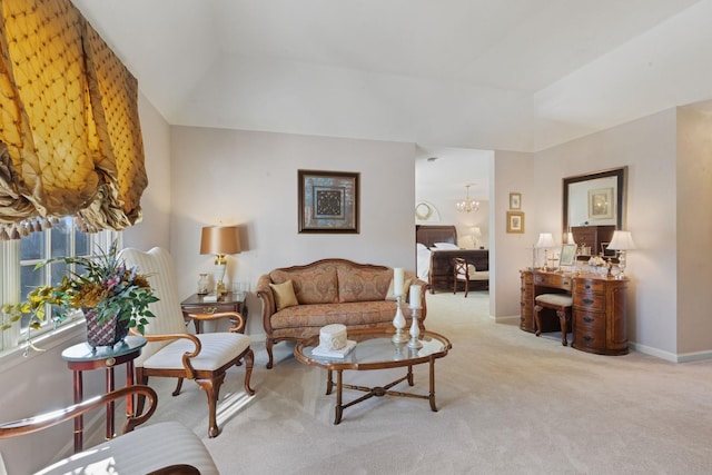 living room featuring light colored carpet, lofted ceiling, and a notable chandelier