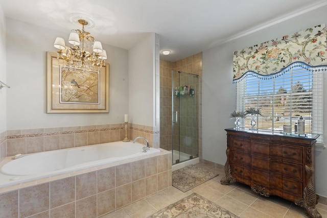 bathroom featuring an inviting chandelier, tile patterned floors, and shower with separate bathtub