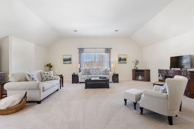 living room with light colored carpet, a fireplace, and vaulted ceiling