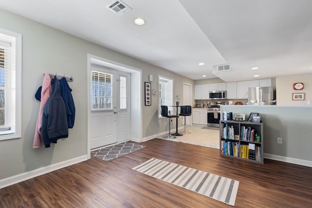 foyer entrance featuring dark hardwood / wood-style floors