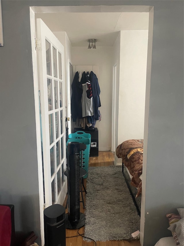 hallway with hardwood / wood-style floors