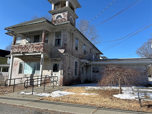 italianate home featuring cooling unit and a balcony