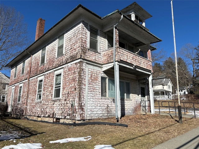 view of side of property featuring a balcony