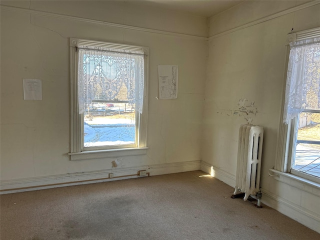 carpeted empty room featuring radiator