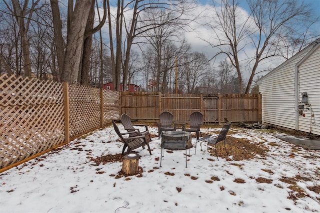 yard layered in snow featuring an outdoor fire pit