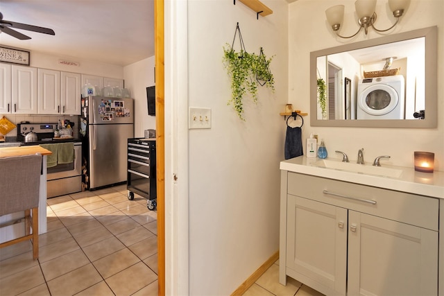 bathroom with stacked washer and dryer, sink, ceiling fan, tile patterned flooring, and backsplash