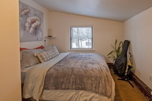 bedroom featuring vaulted ceiling and carpet floors