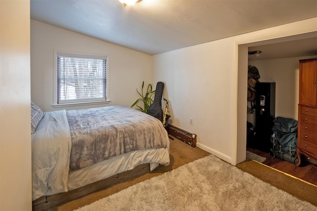 carpeted bedroom featuring lofted ceiling