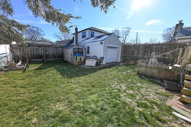 view of yard with a garage and an outdoor structure