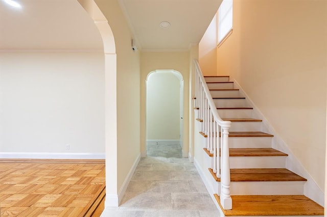 stairs featuring crown molding