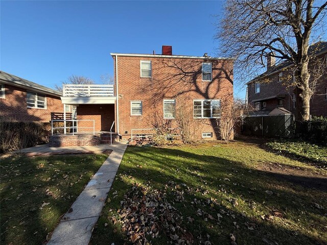 back of property featuring a yard and a patio area