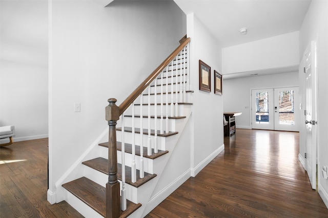 stairs featuring french doors and wood-type flooring