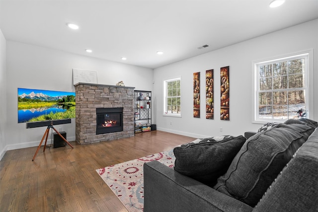 living room featuring a fireplace and dark hardwood / wood-style floors