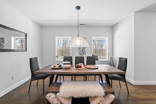 dining space featuring dark hardwood / wood-style floors