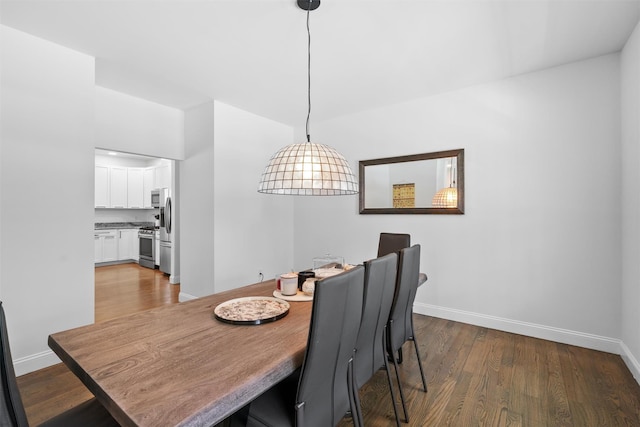 dining space with dark wood-type flooring