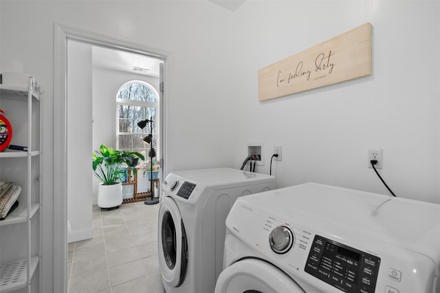 laundry room featuring light tile patterned floors and washer and dryer