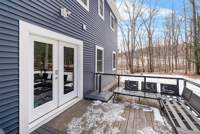 snow covered deck with french doors