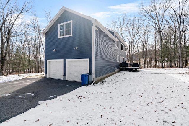 view of snowy exterior with a garage