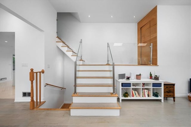 staircase featuring hardwood / wood-style flooring