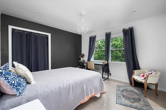 bedroom featuring light hardwood / wood-style floors and a chandelier