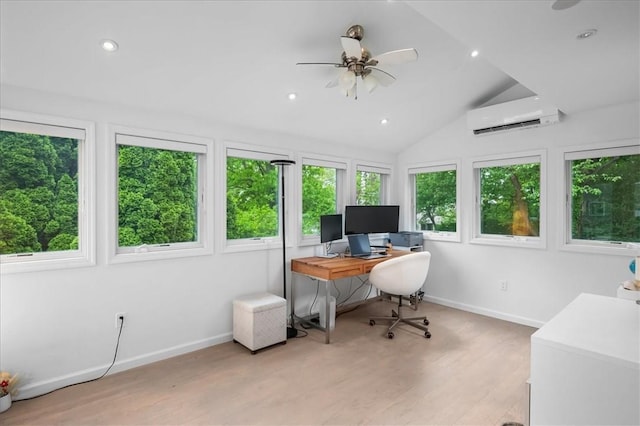 home office featuring a wealth of natural light, vaulted ceiling, a wall mounted AC, and light hardwood / wood-style flooring