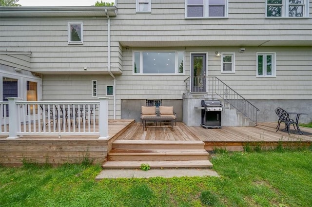 back of property featuring a wooden deck and a lawn