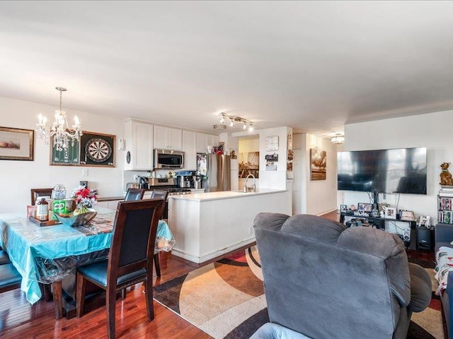 interior space with an inviting chandelier, sink, and hardwood / wood-style flooring