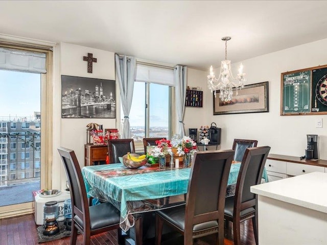 dining space featuring floor to ceiling windows, dark hardwood / wood-style flooring, and a chandelier