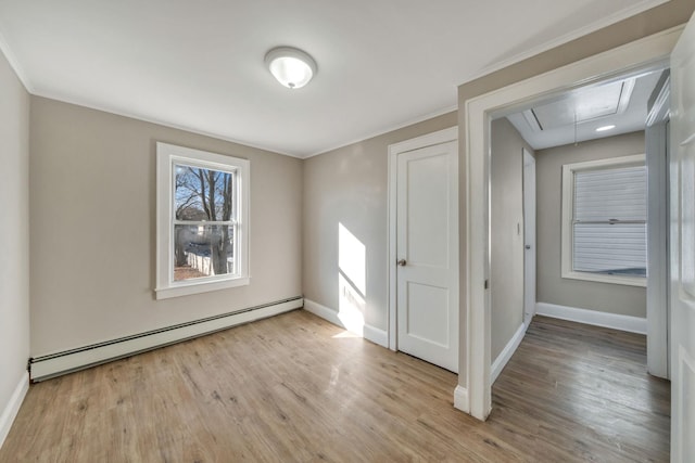 unfurnished room with a baseboard radiator, ornamental molding, and light hardwood / wood-style floors