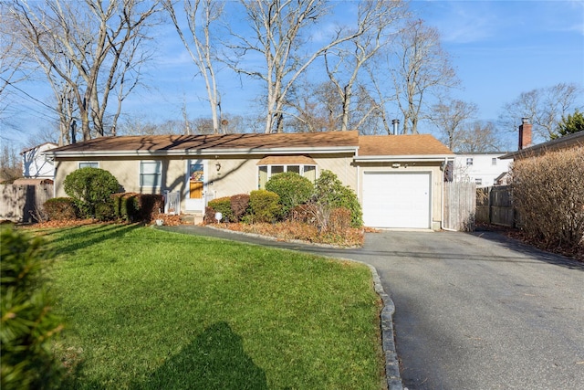 ranch-style home with a garage and a front yard