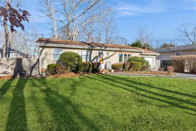 single story home with a garage and a front lawn