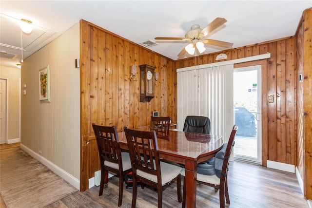 dining space with hardwood / wood-style floors and ceiling fan