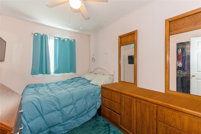 carpeted bedroom with ceiling fan and a closet