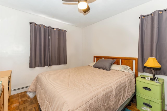 bedroom featuring dark parquet flooring, ceiling fan, and baseboard heating