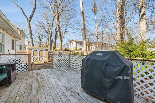 deck with a shed and grilling area