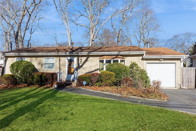 single story home with a garage and a front lawn