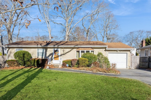 single story home with a garage and a front yard