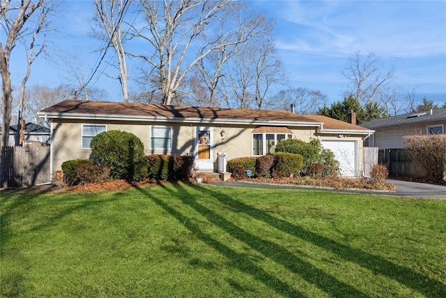 ranch-style home with a garage and a front yard