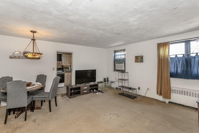 carpeted dining space featuring cooling unit, radiator heating unit, and a textured ceiling