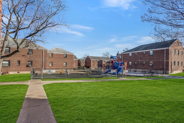 view of home's community with a playground and a yard