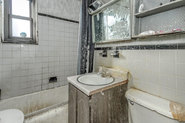 full bathroom featuring vanity, toilet, tile walls, and shower / bath combo