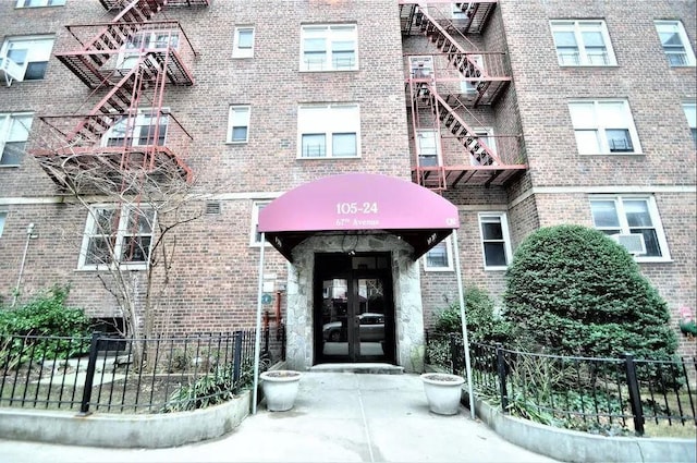 view of exterior entry featuring brick siding