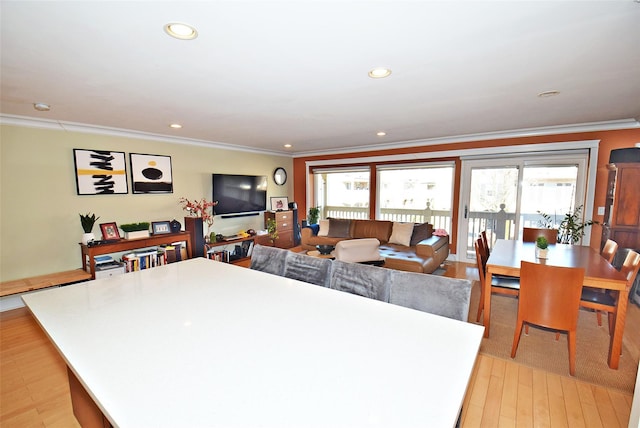 interior space featuring crown molding, light hardwood / wood-style floors, and a center island