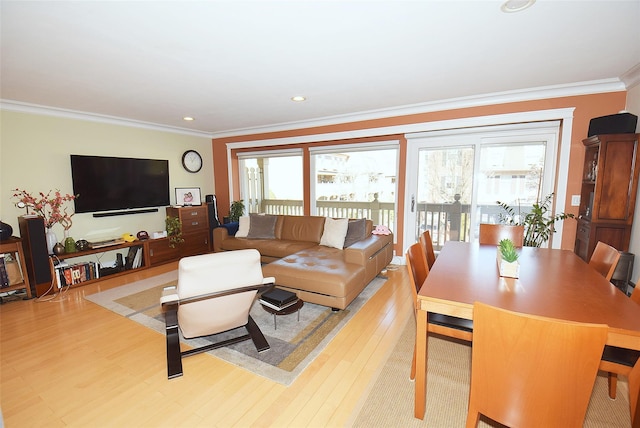 living room featuring crown molding and light wood-type flooring